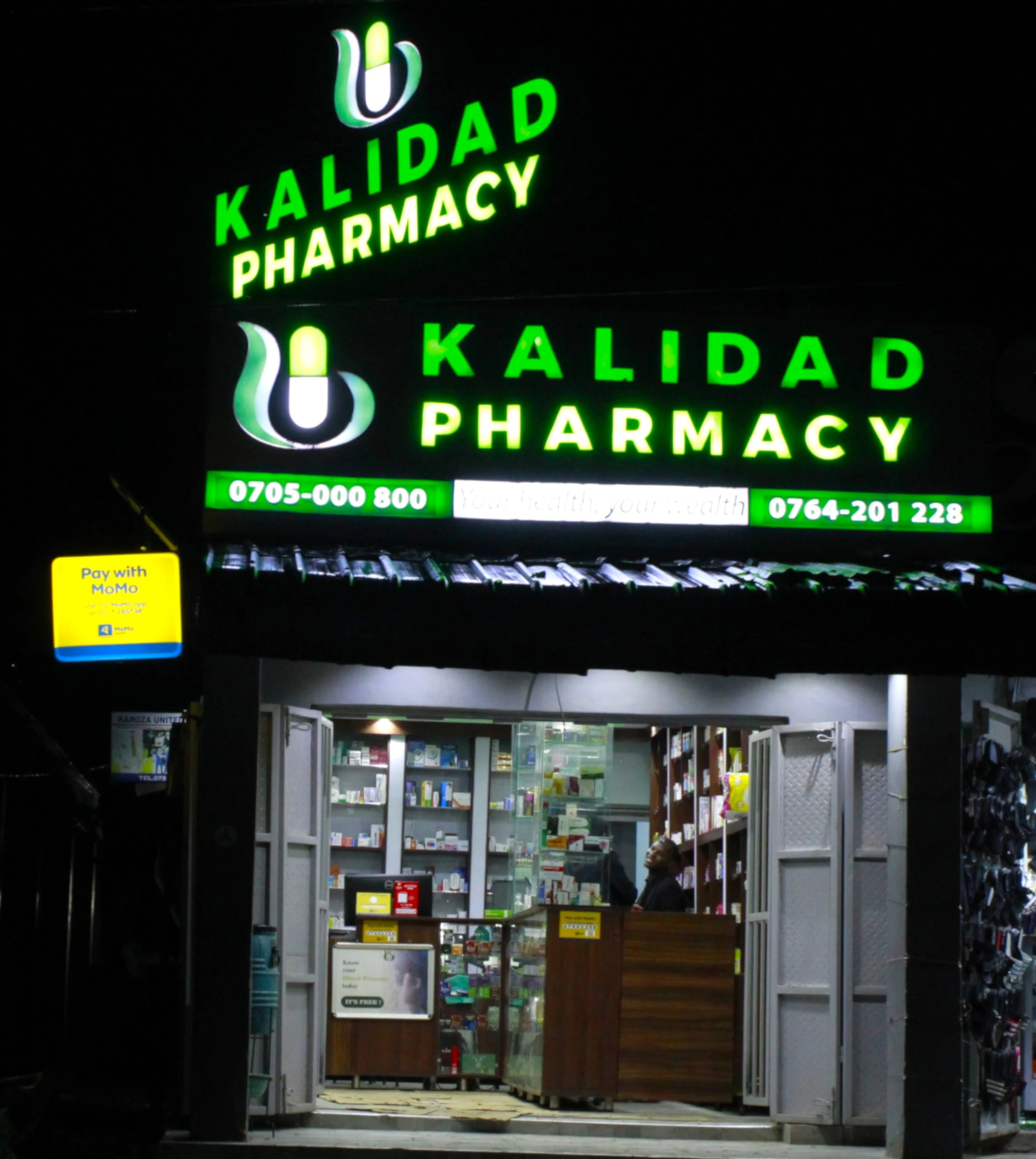 Kisenyi pharmacy interior at night